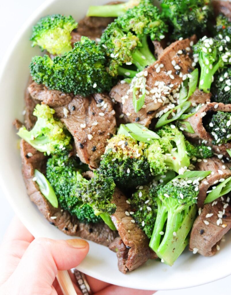 Whole30 Beef and Broccoli Stir Fry, an easy Paleo weeknight dinner made with Flank Steak. I top it with sesame seeds and sliced green onions. Gluten Free!