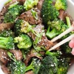 Whole30 Beef and Broccoli Stir Fry, an easy Paleo weeknight dinner made with Flank Steak. I top it with sesame seeds and sliced green onions. Gluten Free!