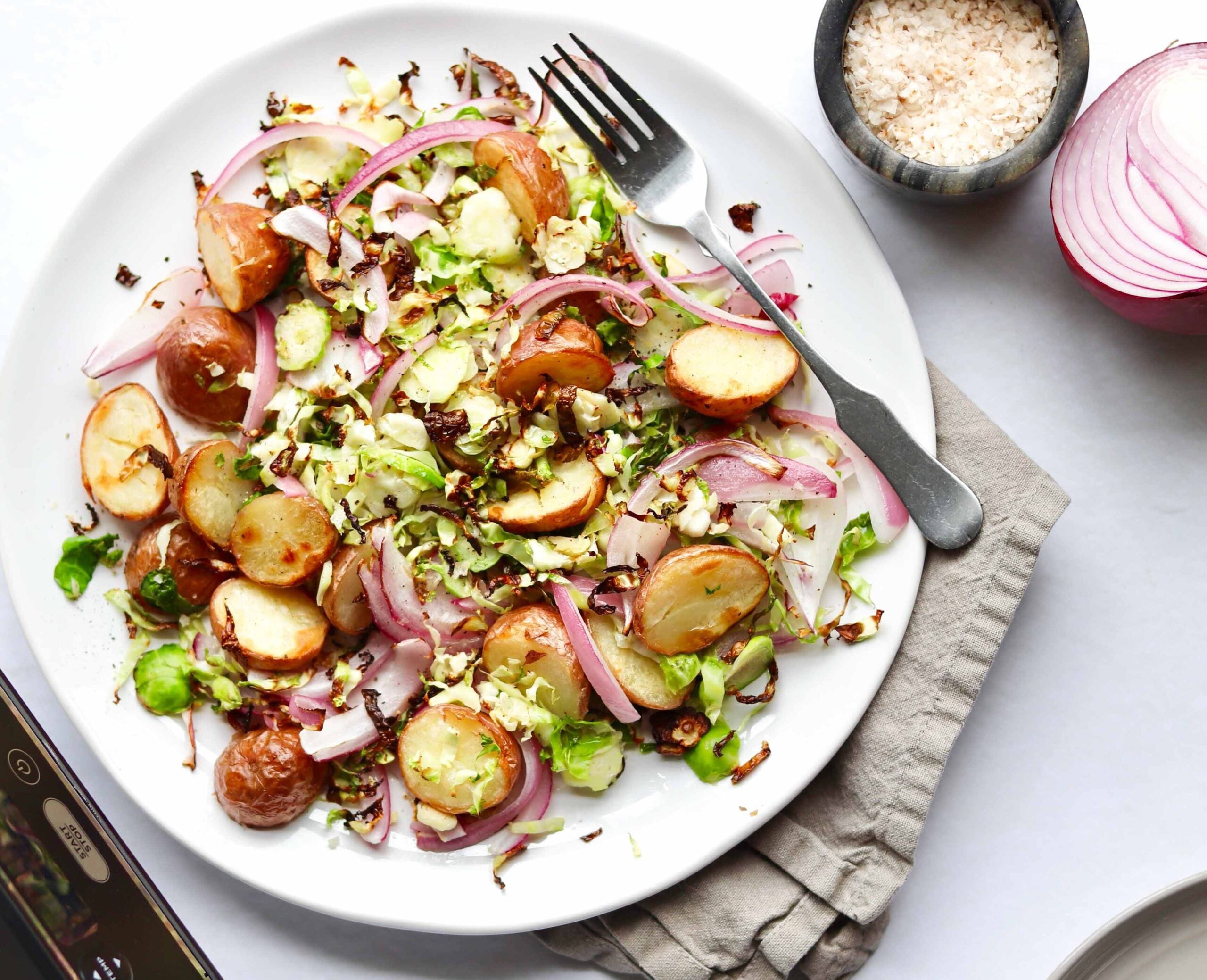 This super fast and totally delicious Whole30 breakfast hash is made with Air Fryer Brussels Sprouts, Baby Potatoes, and Red Onions. Since it's cooked in the air fryer, cooking is quick and mostly hands-off with hardly any cleanup at all! I think it's a great side dish to serve with your healthy breakfast!
