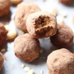 The protein balls on a gray dish. One ball has a bite taken out of it.