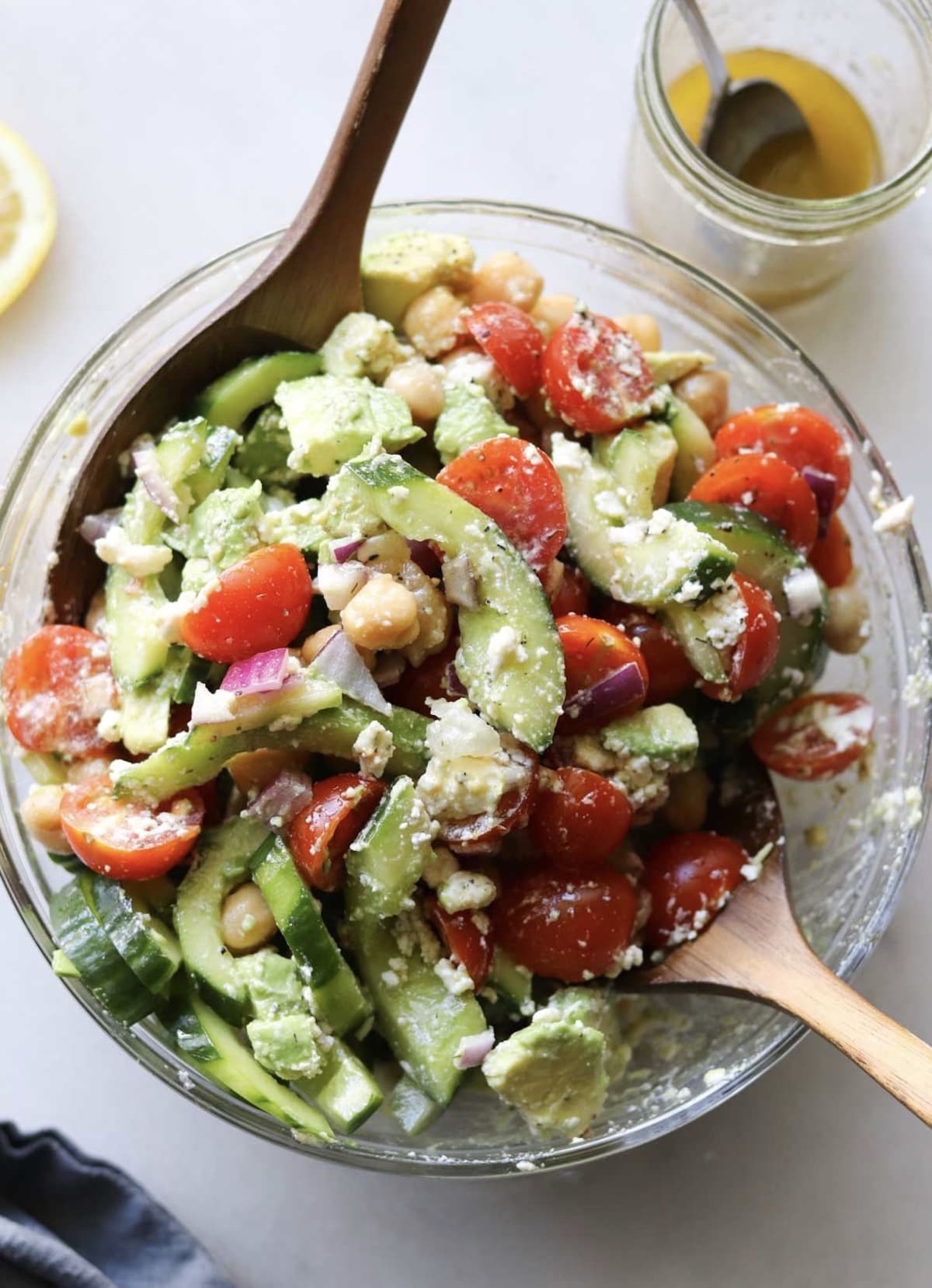 Overhead view of Greek cucumber salad in a bowl with salad tongs