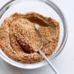 The blackened seasoning in a small glass dish with a tiny spoon.