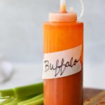 Side view of a plastic condiment bottle labeled "Buffalo Sauce."