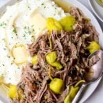 Close up of a plate filled with mashed cauliflower and ketogenic pot roast with pepperoncini.