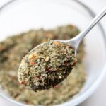Close up of spoonful of Italian seasoning.