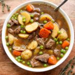 Close up of the finished Irish stew, plated in a white bowl.