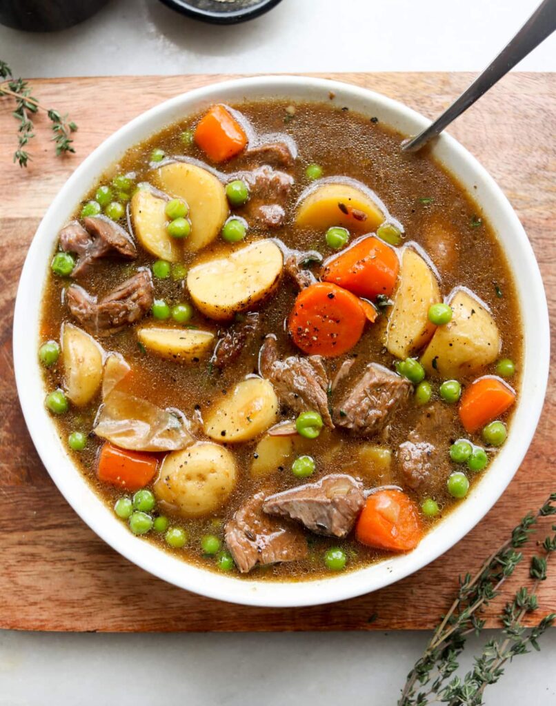 Close up of the finished Irish stew, plated in a white bowl.