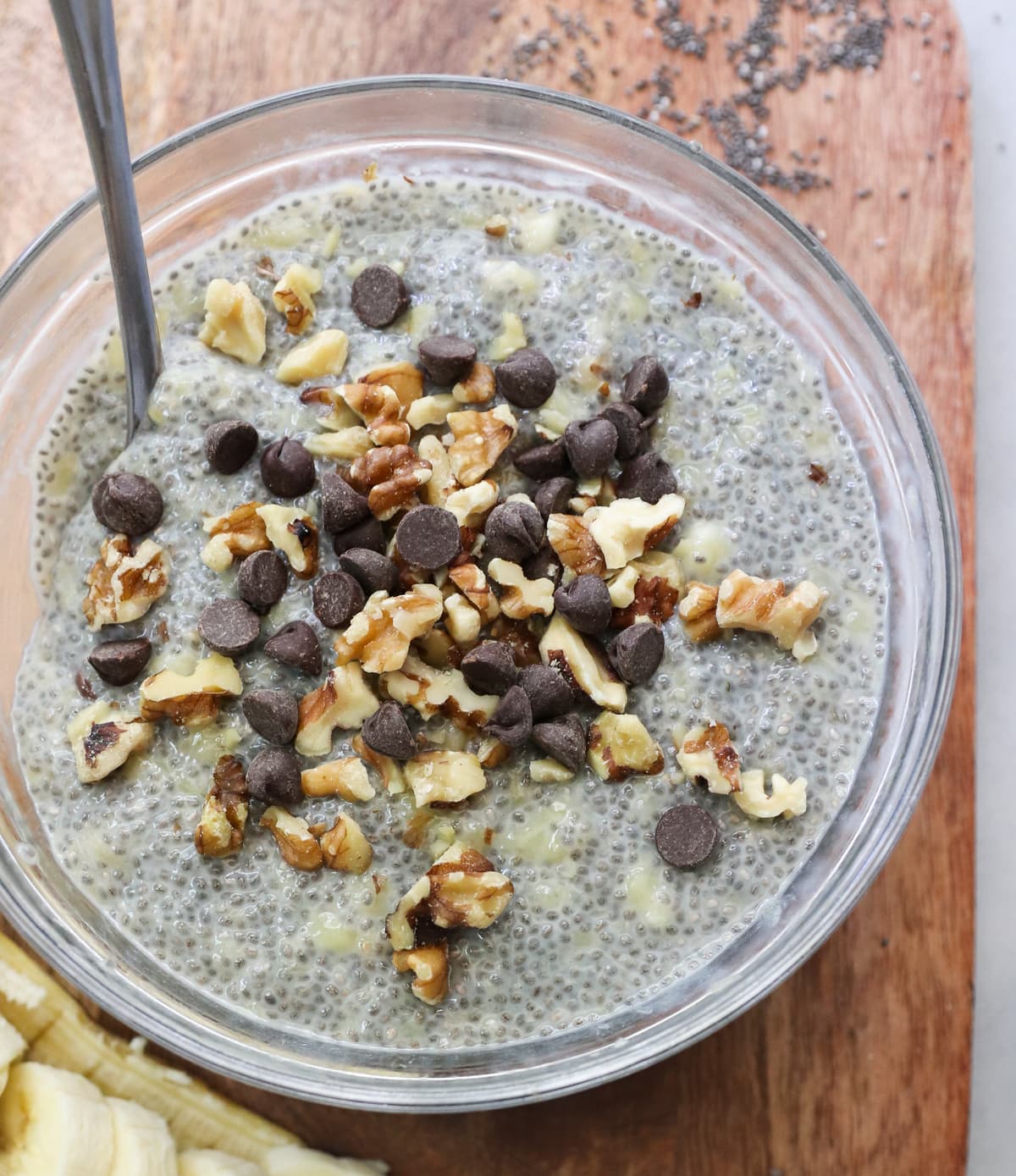 Close up top down of the chia pudding in a large bowl topped with walnuts and chocolate chips. 