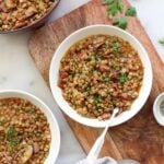 Close up of a bowl of lentils and ham soup.