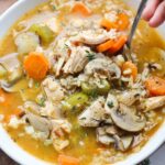 A bowl filled with chicken and rice soup.