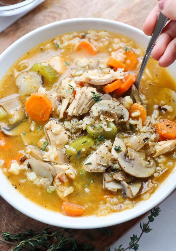 A bowl filled with chicken and rice soup.