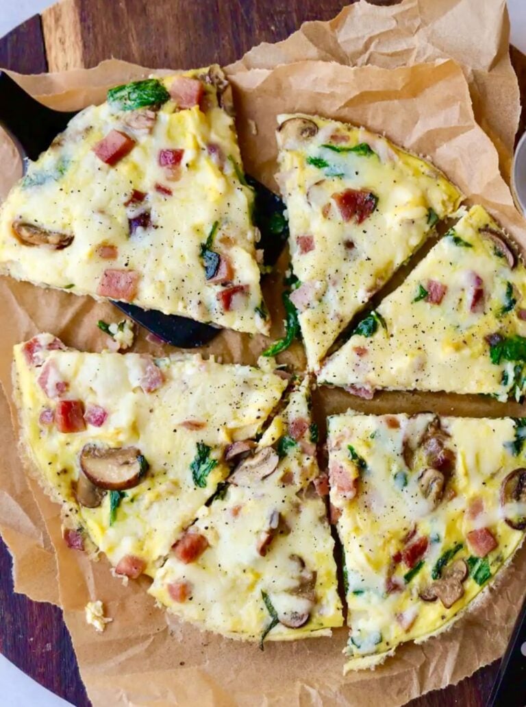 Overhead image of a ham and cheese frittata cut in six slices.
