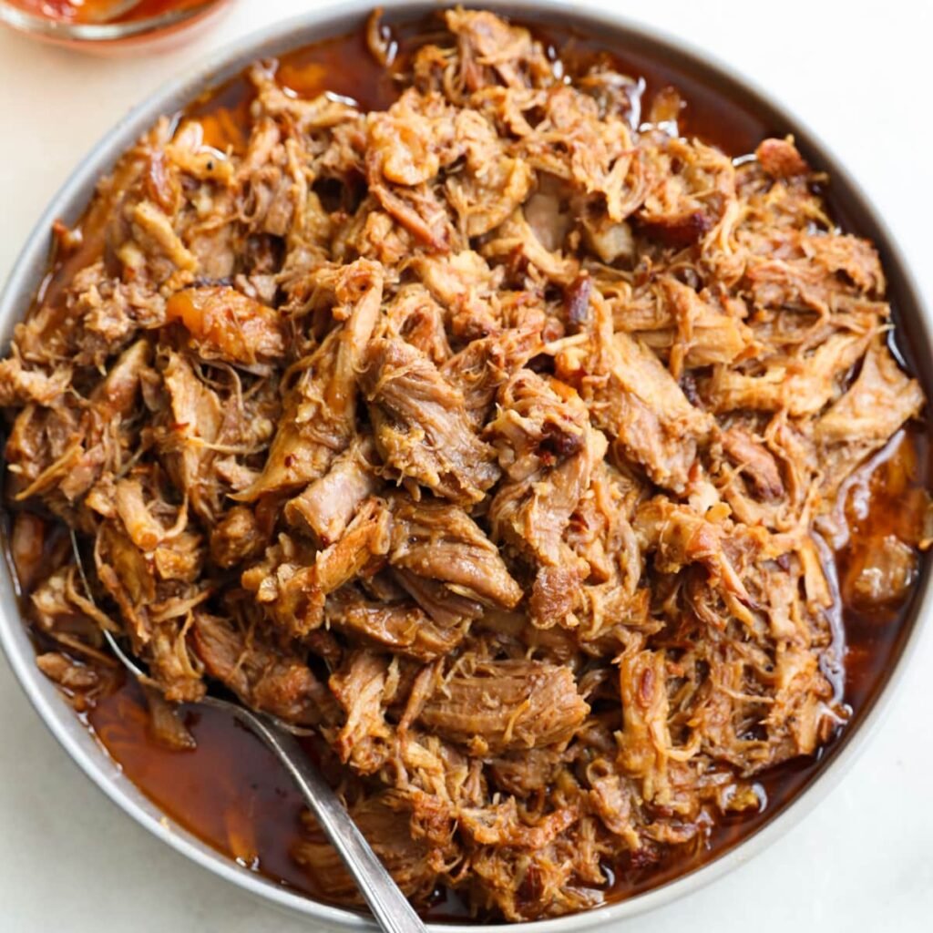 A large bowl filled with tender bbq pulled pork.
