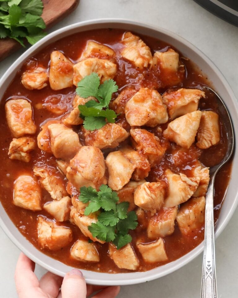 Crock pot sweet Hawaiian chicken in a large serving bowl, viewed from above.