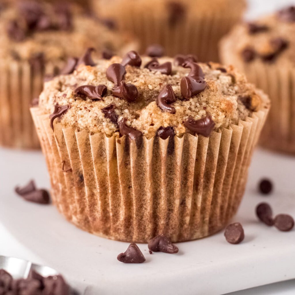 Side view of an almond flour banana muffin with chocolate chips.