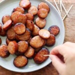 Crispy air fryer cooked slices of kielbasa on a plate.