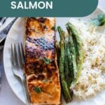 Plate with baked salmon, green beans, and rice. Text overlay reads "Baked Honey Balsamic Salmon" with a cooking badge. Perfect for those who love experimenting in the kitchen, try using a similar sticky-sweet style as you would in a pork chop marinade for an extra burst of flavor.