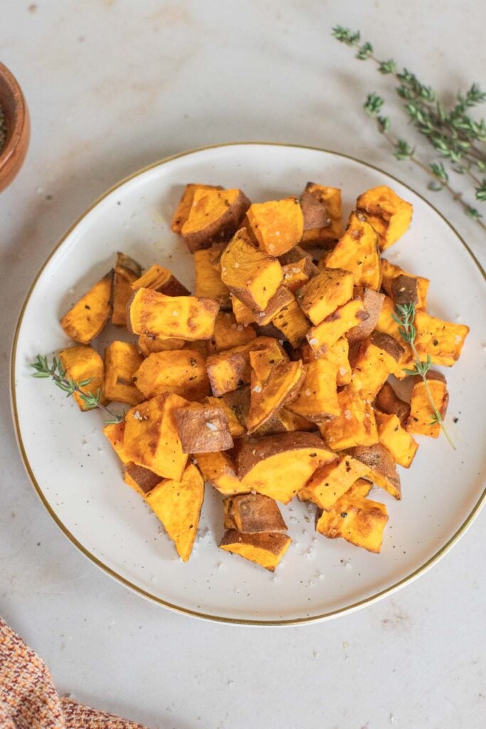 Air-fryer sweet potatoes on a white plate.