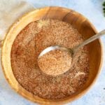 A wooden bowl filled with a dry rub.