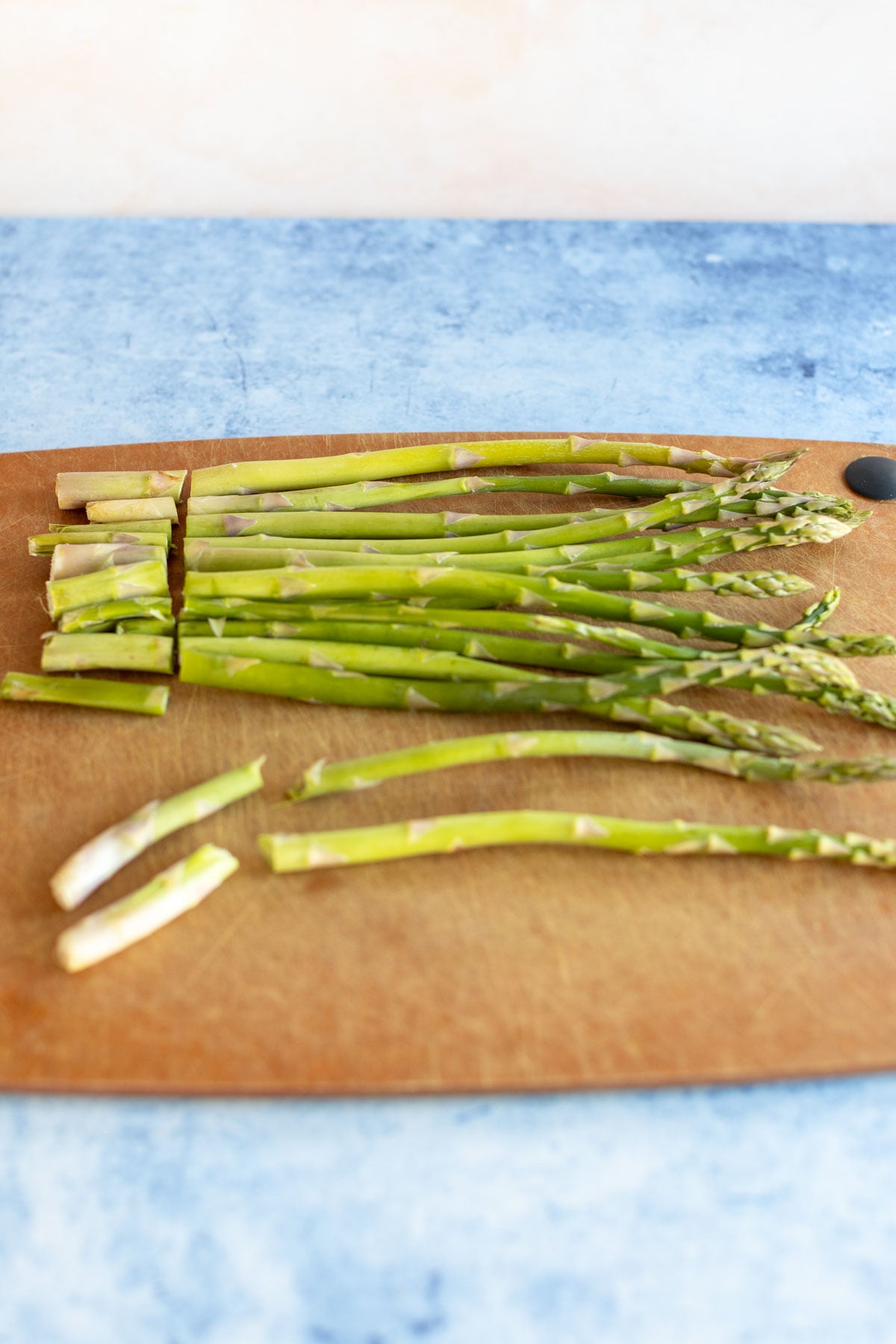 Trimmed asparagus spears on a cutting board.