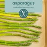 Fresh asparagus spears arranged on a tan tray with a text overlay showing how to freeze asparagus, plus a website link for easy instructions.