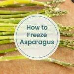 Raw asparagus spears on a cutting board with text overlay that reads "How to Freeze Asparagus"—a step-by-step guide for anyone wondering how to freeze asparagus at home.
