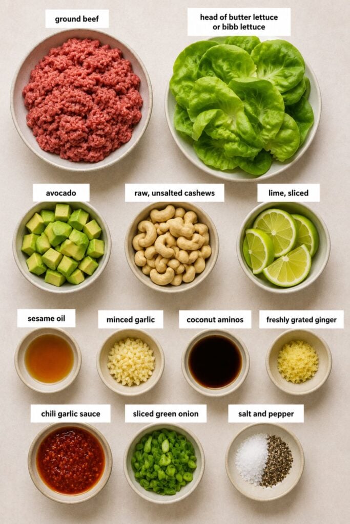 A variety of ingredients in bowls, including ground beef, lettuce, avocado, cashews, lime, sesame oil, garlic, coconut aminos, ginger, chili sauce, green onion, salt, and pepper—everything you need to create flavorful Whole30 Thai Lettuce Wraps.