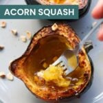 A halved acorn squash cooked in an air fryer, with a fork scooping the tender flesh. Text overlay reads "Air Fryer Acorn Squash" and "cookathomemom.com", bringing warmth like a plate of baked clams oreganata on a cozy evening.