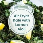 Hand dipping air fryer kale chip into a white sauce with lemon wedges. Text reads "Air Fryer Kale with Lemon Aioli.