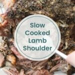 Cooked lamb shoulder seasoned with herbs and spices, being shredded with a fork, reminiscent of tender ranch chicken. Text overlay reads "Slow Cooked Lamb Shoulder.