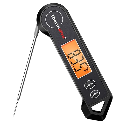 Black digital meat thermometer with a foldable probe, an illuminated LCD screen displaying a temperature of 84.4°F, and buttons labeled "Lock" and "Light.