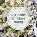 A bowl of dill pickle chicken salad, featuring sliced pickles, chopped red onion, and fresh dill, delivers all the tangy flavors of a veggie salad in every bite.