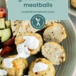 Plate of greek chicken meatballs topped with white sauce, served with salad; overlaid text reads "greek chicken meatballs cookathomemom.com".
