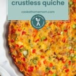 A baked crustless quiche with vegetables sits in a white pie dish, partially shown, featuring a label that reads "crustless quiche" and a website URL displayed on top.
