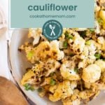 Plate of roasted cauliflower garnished with herbs, with a text overlay that reads "roasted cauliflower" and "cookathomemom.com" at the top. Perfect for anyone craving delicious roasted cauliflower.