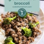 A plate of ground beef and broccoli with white rice, garnished with sesame seeds, served with chopsticks on the side.