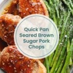 A plate with three glazed pork chops and a serving of cooked asparagus, viewed from above. Similar to baked BBQ chicken thighs, these quick pan-seared brown sugar pork chops make for a delicious meal. Text overlay reads: "Quick Pan Seared Brown Sugar Pork Chops.