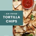 Tortilla chips on a wooden board with a bowl of salsa and cilantro garnish, alongside a label reading "Air Fryer Tortilla Chips.