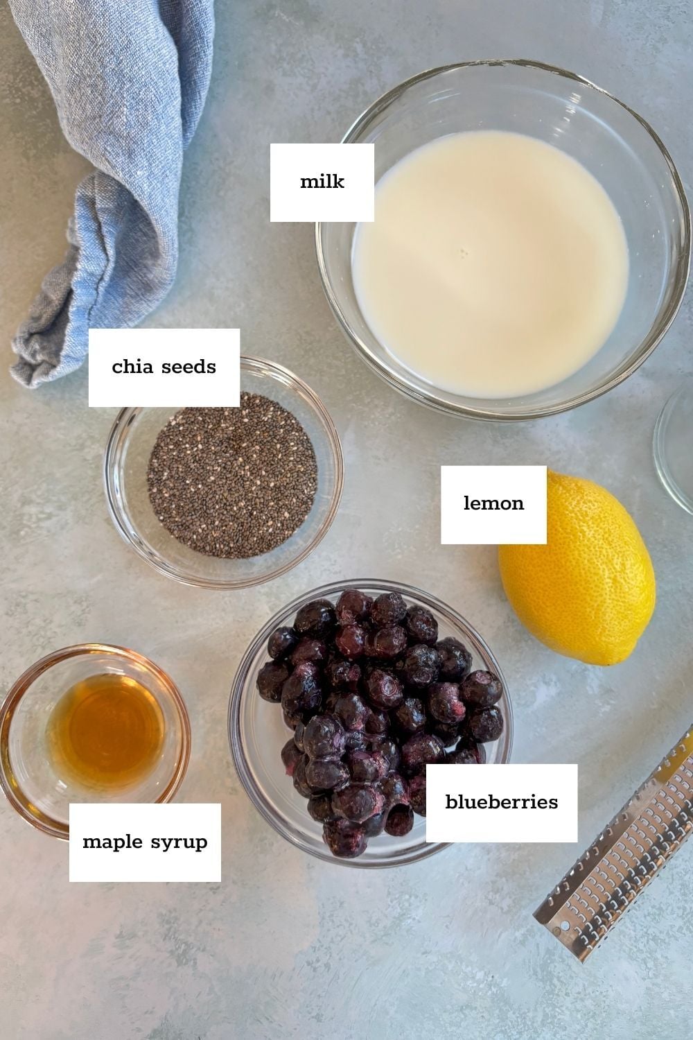 A group of bowls of food, including delicious blueberry chia pudding, is displayed.