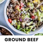 A bowl filled with ground beef, lettuce, black beans, corn, diced tomatoes, red onion, and a lime wedge, with some extra ingredients in bowls nearby. Text reads "Ground Beef Burrito Bowl.