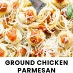 A plate of spaghetti topped with ground chicken meatballs, marinara sauce, and shredded Parmesan cheese.