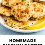 A plate of homemade chicken patties garnished with herbs, served with lemon wedges and a small bowl of dipping sauce.