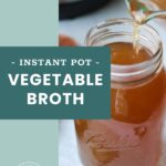 A glass measuring cup pours vegetable broth into a mason jar labeled “Instant Pot Vegetable Broth.” A kitchen appliance is visible in the background.